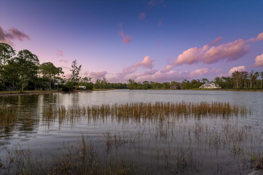 Welcome to 11707 Piping Plover, a spectacular 5 bedroom home with 5 bathrooms, a large game room and office nook. As you enter the home you'll be taken back by the amount of large windows and soaring 16' ceilings in the main area, creating an open concept and bright living space. Admire the captivating long lake view that stretches back for what seems like miles and relax in the 5 acres of private fully fenced property. The home has an alarm system and is purposely positioned alongside the canal for that added space while allowing the rest of the property to be used for a wonderful equestrian facility with the possibility of a convenient second entrance from Reynolds Rd.