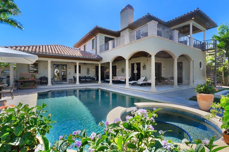 Pristine, custom-built, spacious 4 bedroom, 5 full baths and 1 partial, 2 car garage water front income producing smart home located in Lake Worth, Florida.  Located on a beautiful canal two homes in from the intracoastal waterway with ocean access. Built to code in 2005 with CBC Block all reinforced with cement, high impact windows and French doors, security system, custom wood finishings and Plantation shutters throughout. There is a generator that will run the whole house if you ever lose power. 
The grand front entrance and bottom level include all marble floors that lead through a grand gallery hall. There is a half bath powder room and two large ensuite bedrooms with cherry hardwood floors and beautiful tiled baths. The upper level has another large ensuite bedroom with wood flooring and full tiled bath. It also has the gorgeous master suite appointed with an impressive caste stone wood burning fireplace, large bathroom containing a luxurious claw foot soaking tub, bidet, rain head shower and double sinks.  There is also kitchenette/office and wrap around partially covered master balcony with a panoramic intracoastal view with a separate entry from an outdoor spiral staircase from the lower loggia and pool area. The large highly functional gourmet kitchen has granite counter tops and includes a 6 burner gas stove, double oven, stainless steel appliances and wine coolers. There is a center island that has a second sink and seating for two and space for a table that seats 10. The laundry room is located off the kitchen, which includes hanging rods and lots of storage. Reverse osmosis tanks filter all incoming water. There is an alkaline water dispenser for hot and cold water in the kitchen, and tank located under the main sink in the kitchen on the first and second levels. A butler's door leads into a formal dining room. 
Relax in a huge but cozy family room featuring a gas fireplace complete, large screen TV with surround sound, pool table and library. There is a custom built in wet bar for entertaining. All the French doors and full cabana bath off the family room lead to the outside covered loggia, dock, pool area and outside kitchen complete with a natural gas grill, pizza oven, refrigerator, bar area and counter space where you can dine, relax or just enjoy the view. The dock is equipped with a boat lift that will accommodate a 30' boat.  A Zen garden and orchid shade house surround the west side of the property.