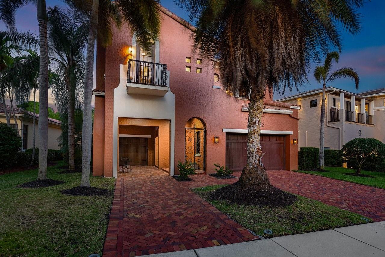 Parkland Golf and Country Club! Idyllic curb appeal with a porte-cochere, charming courtyard with fireplace & balcony. The light-filled interior offers formal living spaces bathed in soft natural light, via walls of glass doors that open to private outdoor spaces. The expansive family room seamlessly connects to a generous open island kitchen & a sunlit breakfast nook. The Primary suite is a private sanctuary, featuring a spa-inspired bath & a balcony overlooking the tranquil backyard. As the sun sets, the magic begins in the backyard via the lighted water features/waterfalls. Other offerings: a 3-car garage, impact windows/doors, loft etc. Timeless elegance blends with resort-style living.