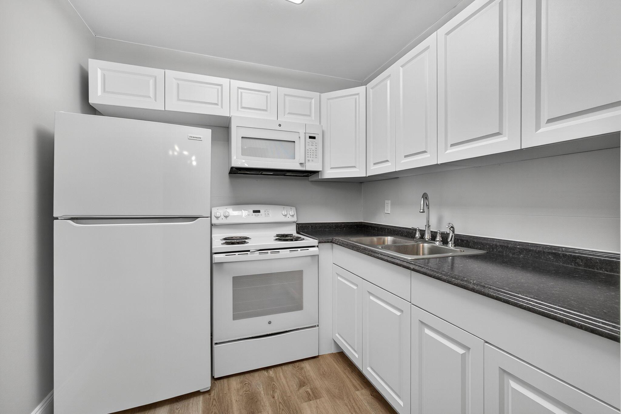 SAY HELLO TO THIS NEWLY RENOVATED 1 BED 1 BATH SECOND FLOOR UNIT LOCATED IN THE HIGHLY DESIRABLE CENTURY VILLAGE GATED COMMUNITY, HOUSING FOR ADULTS 55+. LUXURIOUS VINY FLOORING THROUGH OUT, UPDATED WHITE KITCHEN COMPLETE WITH NEWER APPLIANCES,WHITE SHAKER CABINETS AND A DOUBLE SINK, LARGE PANTRY/CLOSET WITH SHELVING. WHITE UPDATED BATH. HURRICANE IMPACT WINDOWS. GREAT LOCATION SHORT WALK TO CLUBHOUSE AND THE HAVERHILL GATE.WELL MANAGED ASSOCIATION. PET FRIENDLY. RENTABLE AFTER 1 YEAR OF OWNERSHIP Laundry room, assigned parking spot plus visitor parking available; local bus for errands/shopping both within & outside The Village; COME AND ENJOY RESORT STYLE LIVING . CLUBHOUSE features a theater, indoor pool, card room, community/party room, billiard room ,shuffle board ,tennis , pick