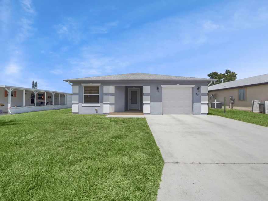 NEW PRICE! Your new Concrete Block Structure home (CBS Home) offers not only strength and durability, but comfort as well. Incredibly maintained, with its open floor plan, your new home features an inviting living room connected to the dining area and kitchen, with breakfast bar complemented by two breakfast chairs. Natural light beams into the rooms as you open your window shutters. First bedroom on left has wardrobe closet and bathroom close by.  Organizer shelved closet is located in the hall off to the right. Master bedroom located in back right corner, with its walk-in closet enjoys some privacy because of tall shrubbery outside. Master bathroom has walk-in sliding glass door shower with seat and extra built in handles for added safety. This Property has a land lease of $743.50/mo. Patio has brick flooring and exterior of home was re-painted approximately 2 years ago. One car garage. Hurricane shutters included. So..... when are you coming over?