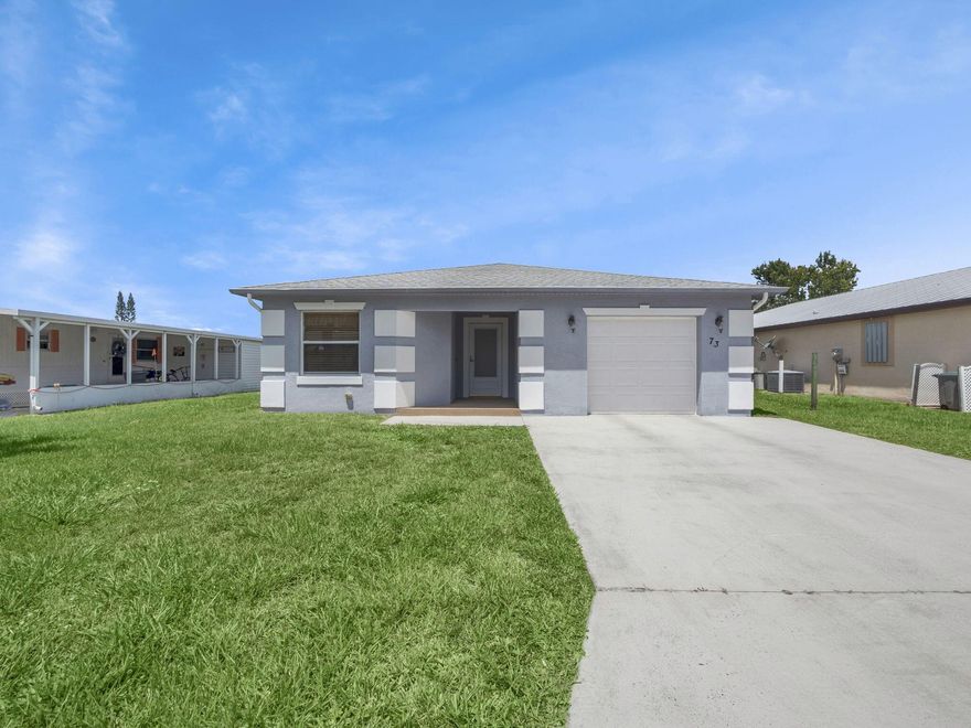 NEW PRICE! Your new Concrete Block Structure home (CBS Home) offers not only strength and durability, but comfort as well. Incredibly maintained, with its open floor plan, your new home features an inviting living room connected to the dining area and kitchen, with breakfast bar complemented by two breakfast chairs. Natural light beams into the rooms as you open your window shutters. First bedroom on left has wardrobe closet and bathroom close by.  Organizer shelved closet is located in the hall off to the right. Master bedroom located in back right corner, with its walk-in closet enjoys some privacy because of tall shrubbery outside. Master bathroom has walk-in sliding glass door shower with seat and extra built in handles for added safety. This Property has a land lease of $743.50/mo.