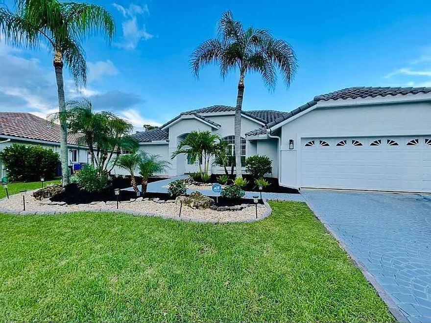 Experience the essence of the West Boca lifestyle in this meticulously maintained 4-bed, 2.5-bath lakefront estate. Built in 1994 for effortless elegance, the bright, open floor plan features picturesque water views from the spacious living areas, formal dining, and a modern kitchen with a large breakfast bar. Retreat to the tranquil master suite or your private backyard oasis, complete with a covered patio, outdoor kitchen, and sparkling saltwater pool overlooking the serene lake. Perfectly positioned within walking distance to top-rated West Boca schools and minutes from championship golf and premier parks, this home blends luxury with convenience. Enjoy a low HOA with access to a clubhouse and heated community pools. This is the ultimate sanctuary in a coveted Boca Raton location.