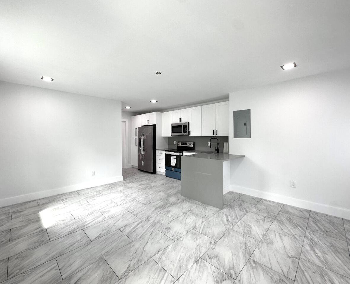 This modern 2-bedroom, 2-bathroom unit has been completely renovated with stylish finishes throughout. From the brand-new tile flooring to the hurricane impact windows, every detail has been thoughtfully designed. The open-concept kitchen and living area create a bright, spacious feel, with a split-bedroom layout offering plenty of privacy.Convenience is key with an included washer and dryer, private driveway parking, and a private backyard for outdoor enjoyment. The property is ideally located just east of I-95, only a few blocks north of Atlantic Blvd, and minutes from the beach, shopping, dining, and local schools. Water is included in the rent.