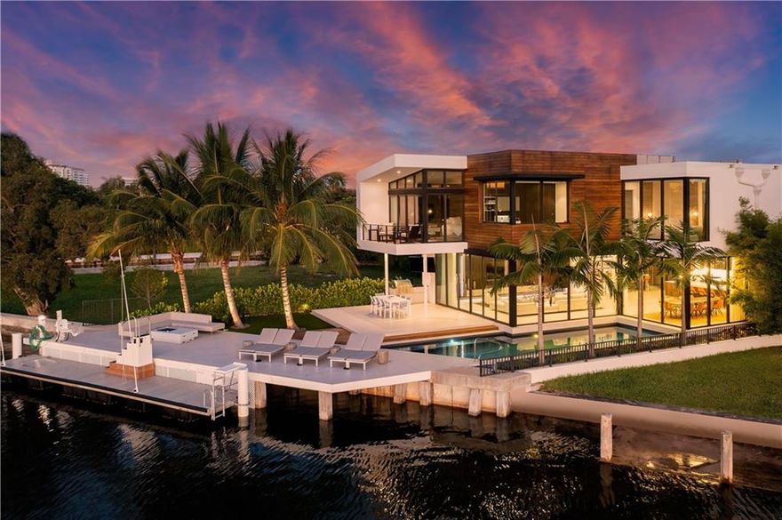 Beautiful modern estate located on Sunset Lake w/ wide water views & easy ocean access! Newer seawall & concrete dock for the avid boater. Open floor plan w/ features that include a wet bar w/ fridge & wine cooler, home theater, kitchen w/ top of the line appliances, gorgeous cabinetry & an extra back kitchen. Light & bright w/ floor to ceiling windows. A floating glass staircase w/ European oak steps leads upstairs to the en-suite guest rooms & large master suite w/ private balcony, dual walk-in closets, water closets & morning bar. Outdoor living space w/ pool, BBQ & fire table. Home is equipped w/ elevator, natural gas, backup generator, custom landscape lighting, 2 laundry rooms & central vacuum system. 3 car garage w/ room for lifts for poss 6 spaces. Furniture negotiable.