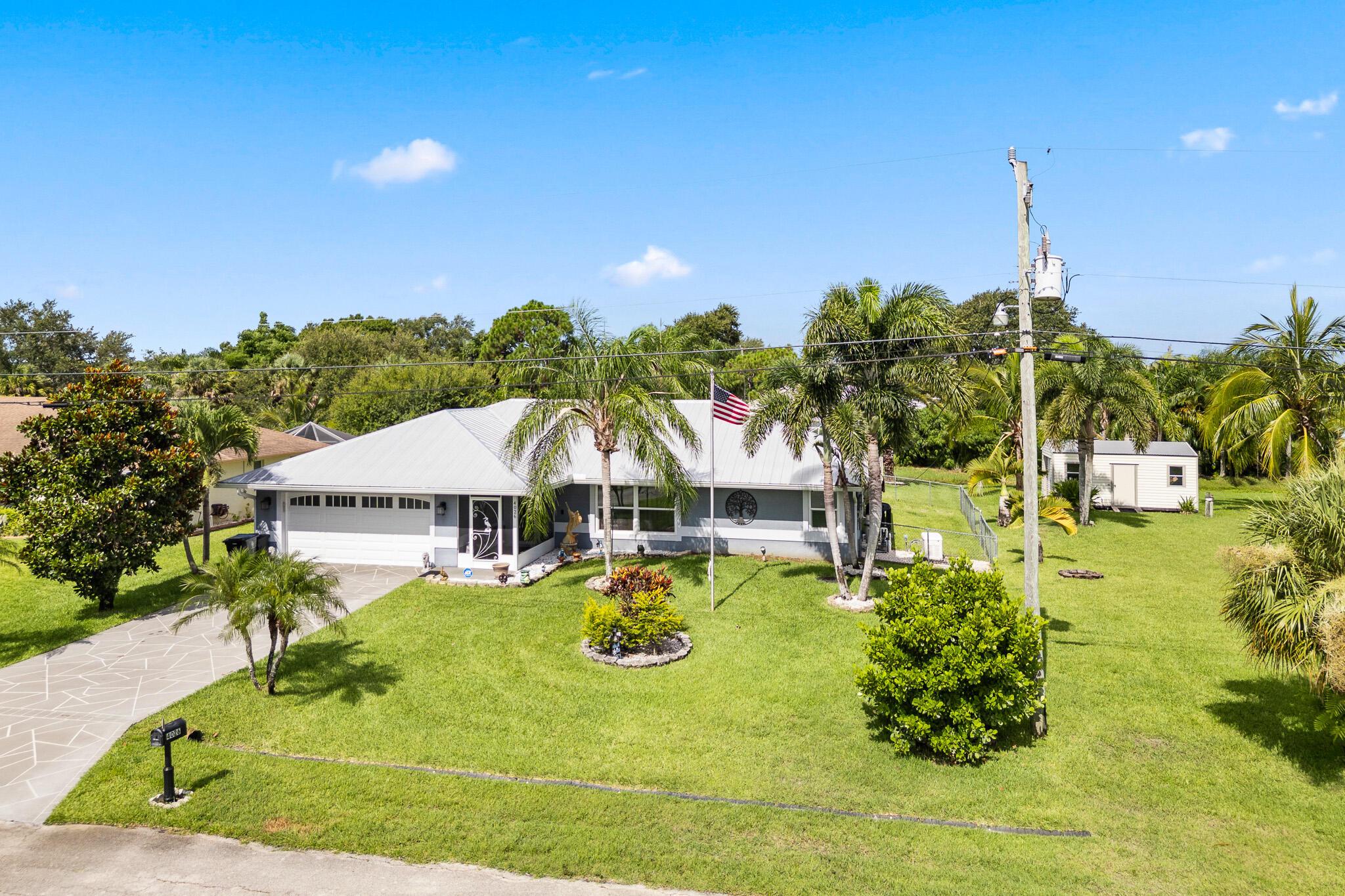 Built in 2009, this Port St. Lucie concrete block home offers 2,126 sq ft on a 0.46-acre double lot with no HOA. Features a 2021 metal roof, large screened-in pool, and open-concept kitchen with granite countertops. Spacious living areas, two-car garage, and multiple sheds for extra storage. Enjoy comfort, space, and Florida living!