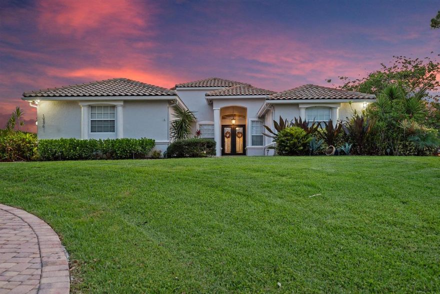 Elegant lakefront estate nestled in a tranquil cul-de-sac, offering sweeping sunset views over a private 20 acre lake. Set on serene .68-acre lot, this residence boasts 4 bedrooms(possible 5), 3 full baths, 2 spacious primary suites w/walkin closets, plus an office/den. The lanai w/pool, spa, outdoor pergola w/builtin grill, firepit creates the ultimate retreat. Features include 2 new AC units,new well, newer appliances, LED lighting, updated kitchen w/granite, reverse osmosis,fresh interior paint, outside painted 2021, circular driveway, 3 car garage, complete hurricane protection to add peace of mind, fruit trees and garden.The Cape Club golf membership is avalable not mandatory. 24/7 guardgated community w/low HOA. Experience unapparelled privacy, elegance, lakeside living at its finest