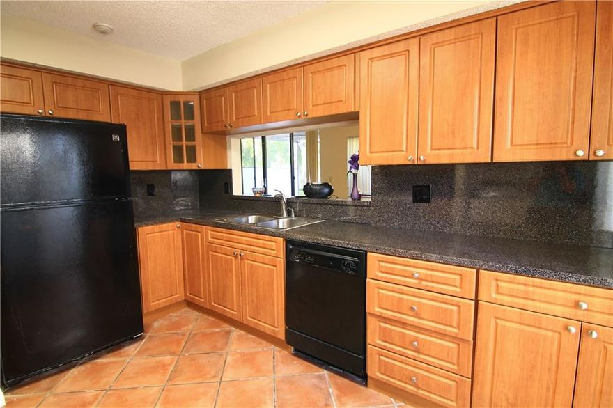 RARELY AVAILABLE CORNER UNIT IN DESIRABLE TERRA BELLA TOWNHOMES.  FEATURING GRANITE LIKE COUNTERTOPS,  AND STAINLESS KITCHEN, WOOD CABINETRY, TILED FLOORS, WOOD LAMINATE IN ALL BEDROOMS AND UPGRADED BATHROOMS.  OPEN AIRY AND SPACIOUS WITH TWO PARKING SPACES.  LOCATED CLOSE TO TENNIS COURTS AND POOL.  A MUST SEE!