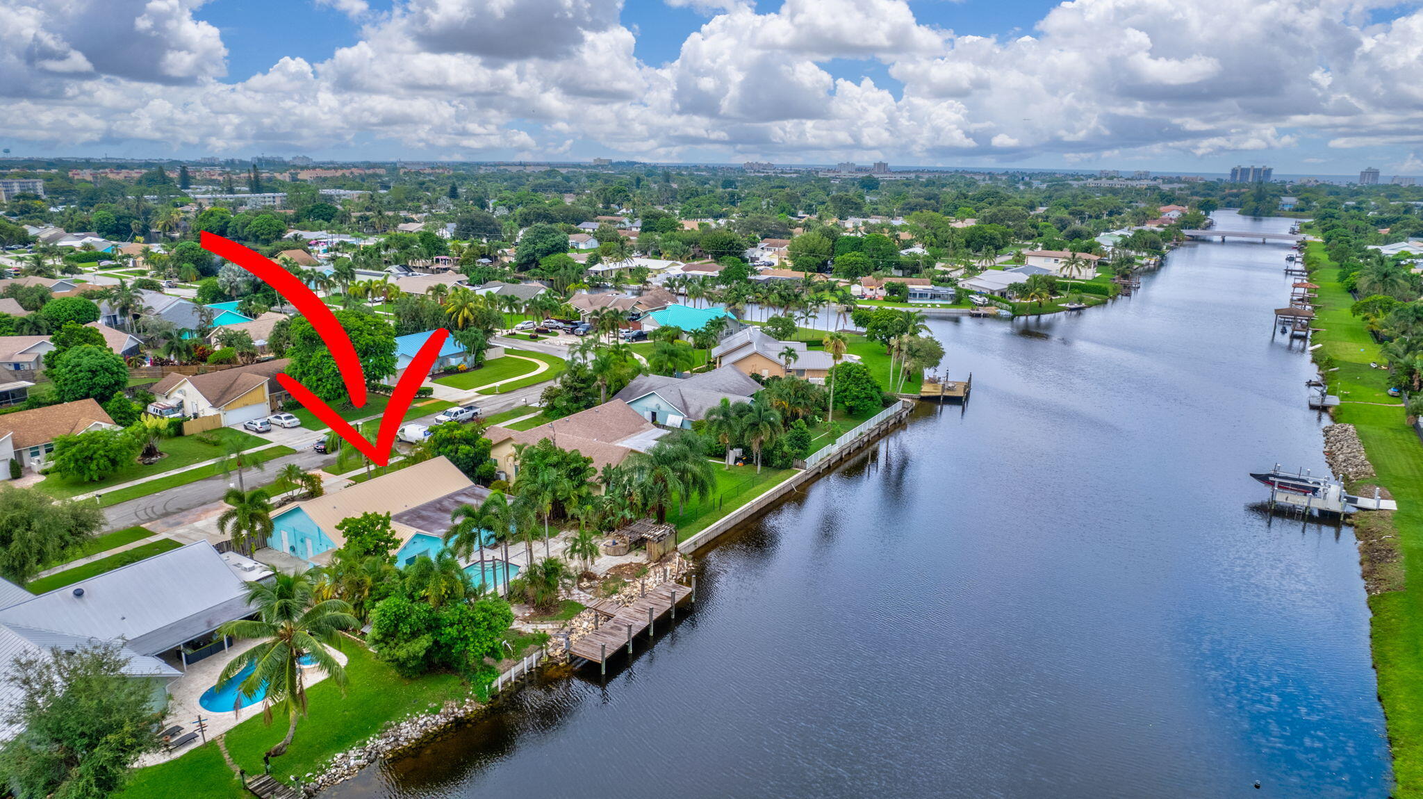 Tropical paradise awaits you at this beautiful, waterfront gem in Delray. The brand-new dock awaits your boats, kayaks, jet skis & paddleboards. The property is located in a gorgeous, quiet, artistically landscaped neighborhood just a stone's throw from Atlantic Avenue. Beneath the new aluminum roof, a generous, open-concept floor plan exceeding 1,900 square feet is unified by consistent ceramic tile flooring throughout. Even the laundry room is huge. Two of the bedrooms are waterfront. Fitted closets for organized storage. You won't want to leave the backyard! Zen vibes abound. Palm trees surround the private pool, maintained by owner. The avocado tree produces year-round. There's great space for grilling & landscaping, even a couple hooks awaiting your hammock. Plenty of room for
