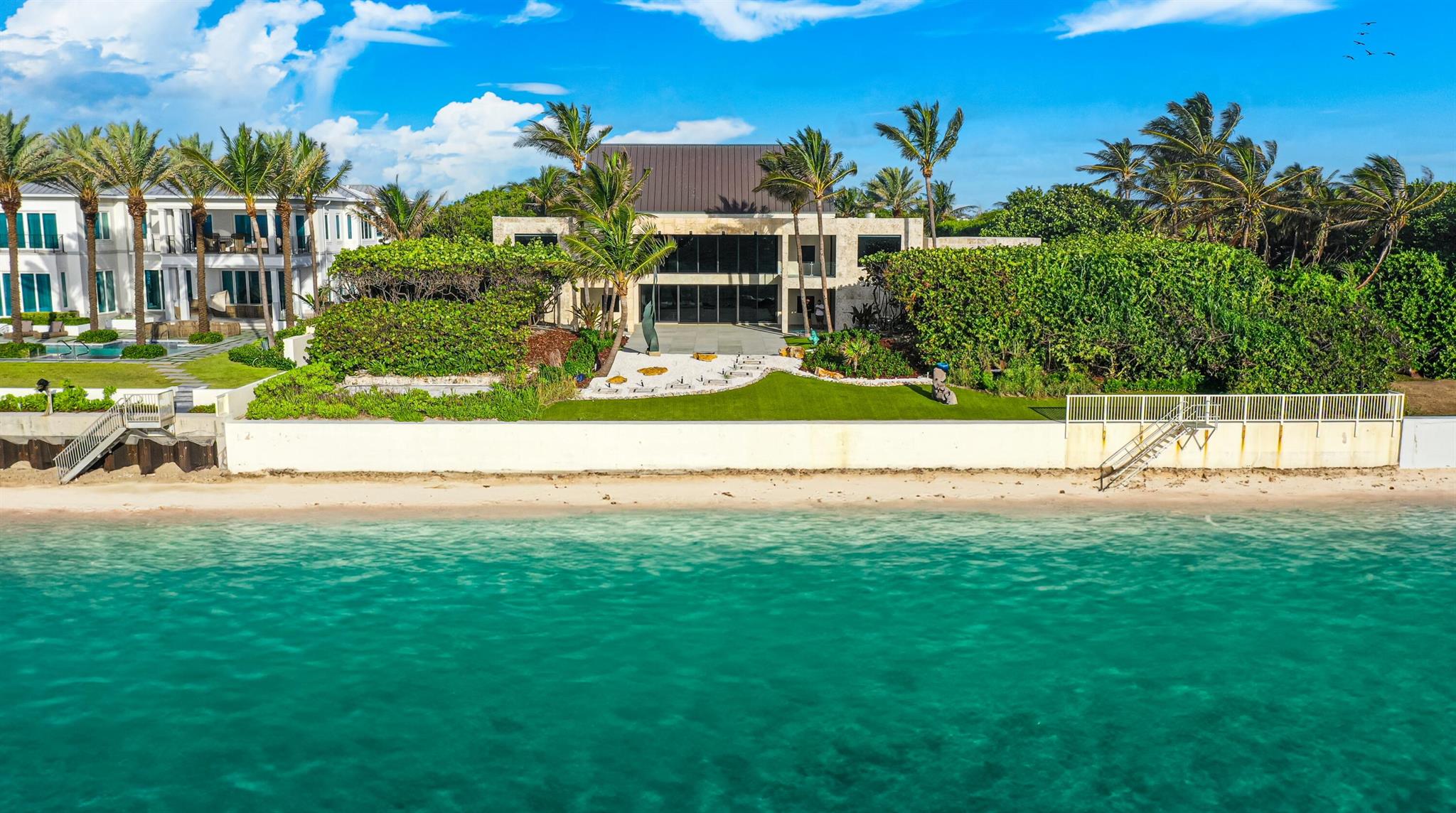 With renovations now complete, this high-elevation, coquina-clad estate presides over 150 feet both on the ocean and Intracoastal. A stunning collaboration between an award-winning architectural firm and renowned landscape architect, this luxe showcase captures the essence of opulence and excellence, with lofty ceilings, ocean-view window walls, a koi pond, sculpture gardens and cascading fountains.