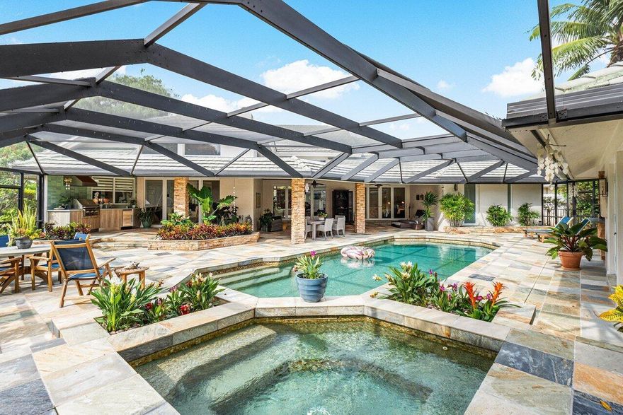 Discover one of the finest estates in Broken Sound, now on the market. This home has been updated with the highest quality finishes and features a casually elegant contemporary design. It offers impact windows and doors throughout, rich wood floors, a stylish formal living room, a spacious dining area, and a chef's dream kitchen with a Viking gas range, large island, and top-of-the-line appliances. The serene primary suite includes a spa-inspired bathroom and an expansive custom closet. Additional highlights include a guest suite, executive office, two upstairs bedroom suites, a screened patio with a heated saltwater pool with total privacy, summer kitchen and detached guest house. Located on one of the community's largest lots, this estate offers space and elegance in resort-style living