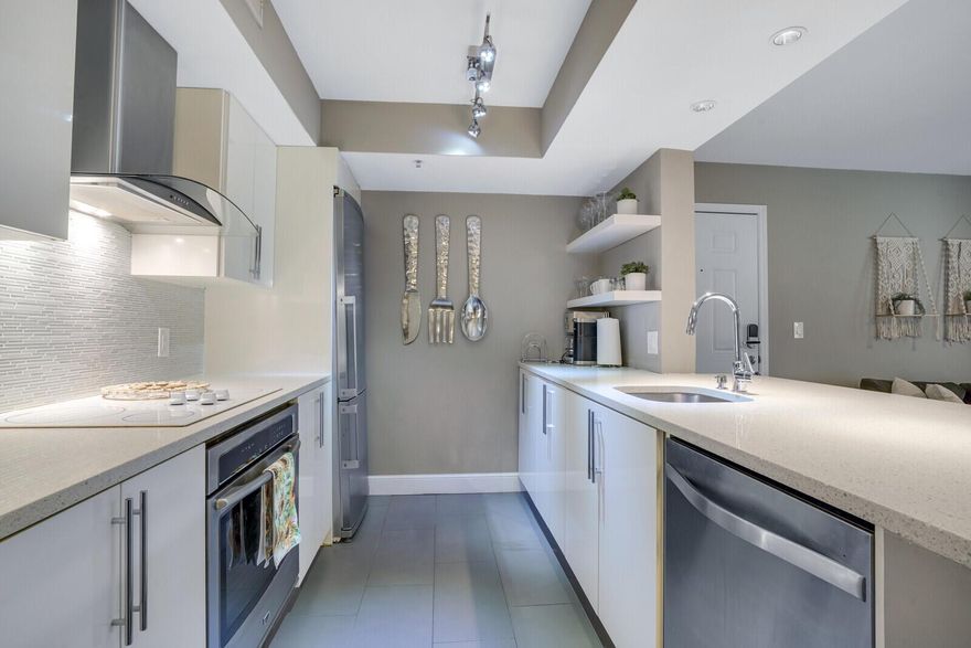 Stunning 2/1 ground-floor condo in the highly sought-after Yacht Club on the Intracoastal. FURNISHED. This beautifully custom-designed, turnkey residence is located in a gated, resort-style community and features a peaceful garden view, a private covered patio perfect for outdoor dining, and an open-concept layout ideal for modern living. The interior showcases a sleek stainless-steel kitchen with quartz countertops, custom cabinetry, designer lighting, and custom wallpaper in the dining area. The spacious primary bedroom includes a generous walk-in closet, and both bedrooms are thoughtfully appointed for comfort and style. Enjoy acres of lush, landscaped grounds and top-tier amenities including two pools directly on the Intracoastal for boat watching and beachy living