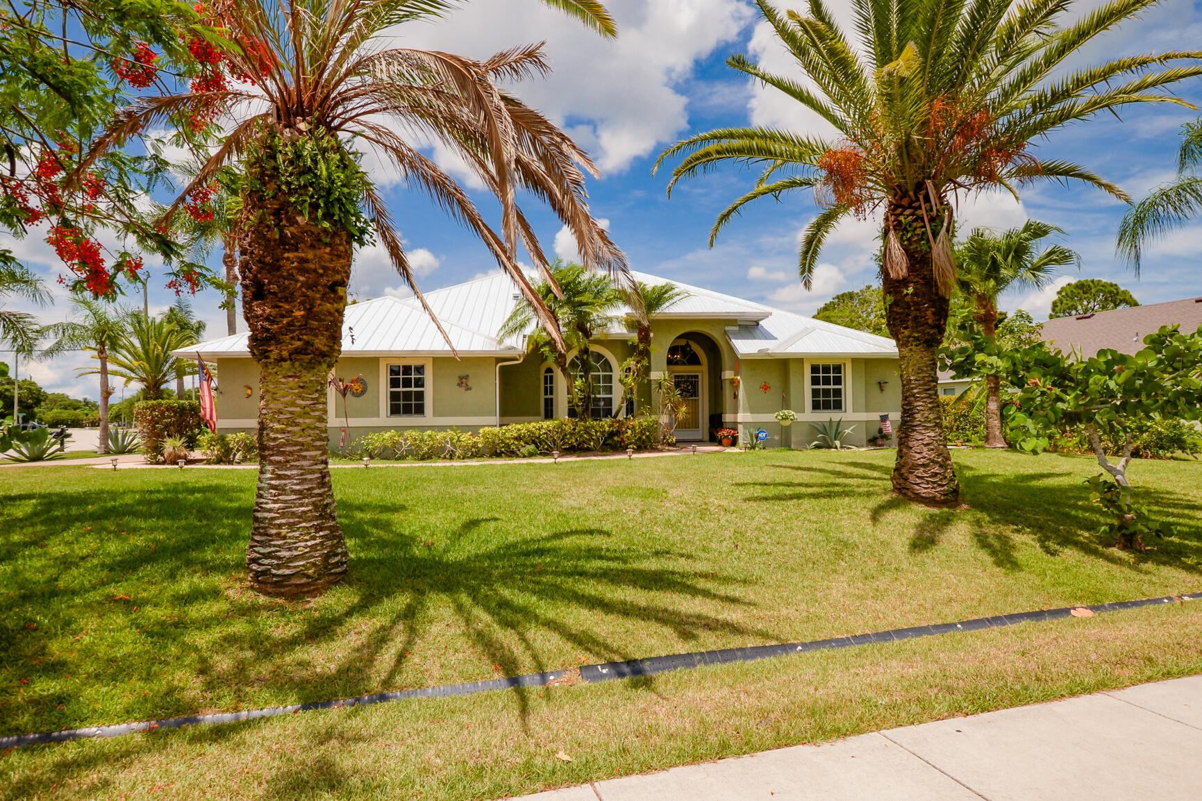 Beautifully maintained 3 Br 2 bath pool home is situated in an established family friendly neighborhood in the NW section of the city. Home has an excellent curb appeal with wonderful landscaping. The layout of the home perfect for both everyday living and entertaining. The expansive corner lot with fruit trees and screened in pool and patio area designed for outdoor entertainment. Home has metal roof installed in 2020 and AC is only 3 yrs old. Convenient access to shopping, dining, I-95 and the Fl Turnpike. Don't miss out on the opportunity to make this your new home. Existing loan on solar panels. Call today for showing.