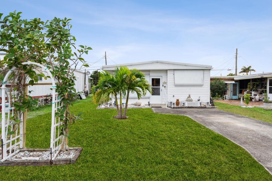 Enjoy this nicely updated home.  The kitchen is beautifully renovated with updated appliances.  It is bright and white.  The living room is spacious.  The home features newer flooring, an oversized master bedroom, air conditioned laundry room, and a screened patio.  You own your own land!  The association fee is extremely low to include water and community amenities.  The association allows you to fence your propery.