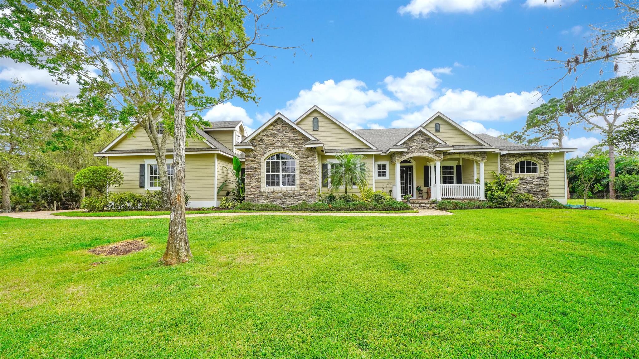 Welcome to your dream home in Palm Beach Country Estates! This custom-built 6-bed, 2.3-acre pool retreat offers mid-community ease with a paved road for accessibility. Step inside to hardwood floors, elegant marble and granite in all baths, and a gourmet kitchen featuring stainless steel appliances, double ovens, and a gas stove--perfect for entertaining. Experience luxury and comfort in this stunning residence.