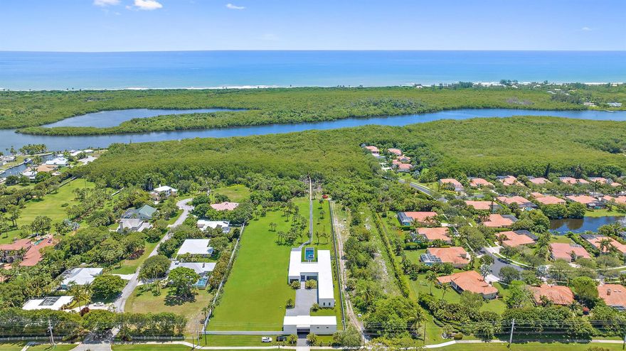 New Contemporary Home built in 2022 on over 4 acres of private Intracoastal property plus 2 acre lot next door. Perfect for the car collector or boater with 8 garages plus room for car lifts, and over a 100' of direct Intracoastal frontage. Sleek and clean lines, large floor to ceiling windows with long views of property and pool, 3 bedrooms in the main house and a detached guest suite with full bath and kitchen, theater, and office/exercise room.  Luxurious Owners Retreat with wood floors, fireplace, marble bath, dual sinks and water closets and a walk-in boutique style closet. State of the art contemporary kitchen with 2 wall ovens, wine wall, gas stove, push open refrigerators and freezer, butler's pantry & oversized walk-in pantry.