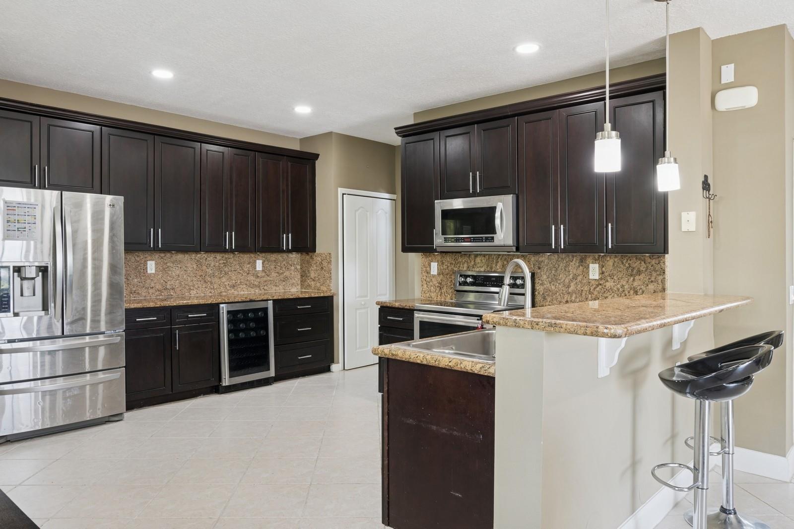 Welcome to pure elegance in Miramar! This fabulous 4-bedroom, 2.5-bath beauty is the perfect blend of comfort and sophistication. Step into a bright, open layout where the designer kitchen with its sleek granite counters and stainless steel finishes makes every meal feel like a celebration. The backyard? An absolute dream—lush, private, and made for poolside lounging with a chilled glass of rosé. And yes, there’s a sparkling pool to enjoy all year round. This home is situated on a premium waterfront lot, offering extra space and privacy.
Freshly painted throughout, this home exudes a modern, clean feel. Nestled in a serene, upscale neighborhood just minutes from chic shops, fine dining, and top schools, this home has it all. It's not just a house, it's a lifestyle.