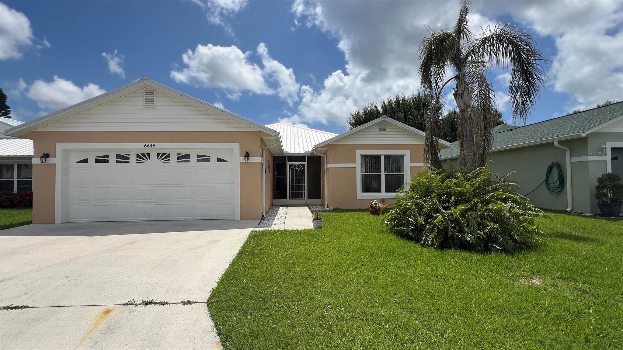 This beautifully upgraded concrete block (CBS) home features 3 spacious bedrooms, 2 bathrooms, and a 2-car garage, in a 55+ community on leased land. Enjoy the Florida lifestyle from the large screened-in patio and covered porch--perfect for relaxing or entertaining.Inside, you'll find tile flooring throughout, walk-in closets for ample storage, and a modern kitchen equipped with stainless steel appliances. Conveniently located close to I-95.