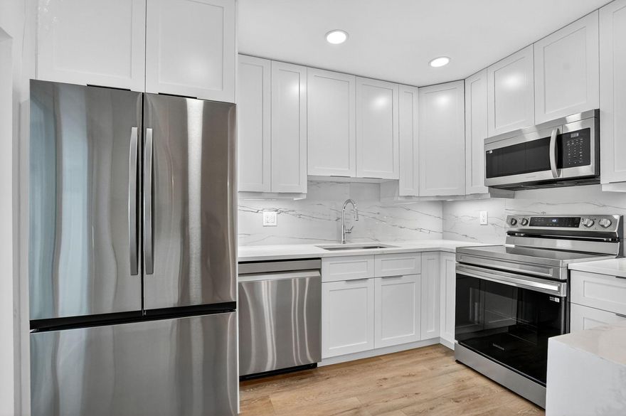 Welcome to Martel Arms, where coastal charm meets convenience in this rarely available 1,400 sq ft courtyard townhome. Ideally positioned with northeast exposure, this light-filled 2-bedroom, 2-bath residence is just a short walk to Delray's beautiful North End Beach and only one mile from the vibrant Atlantic Avenue. Totally renovated from top to bottom, brand new kitchen, appliances, flooring, and bathrooms!   Pet-friendly (2 pets allowed, no size limit, no vicious breeds) Courtyard is great for outdoor living, grilling, sunbathing, and outdoor dining!