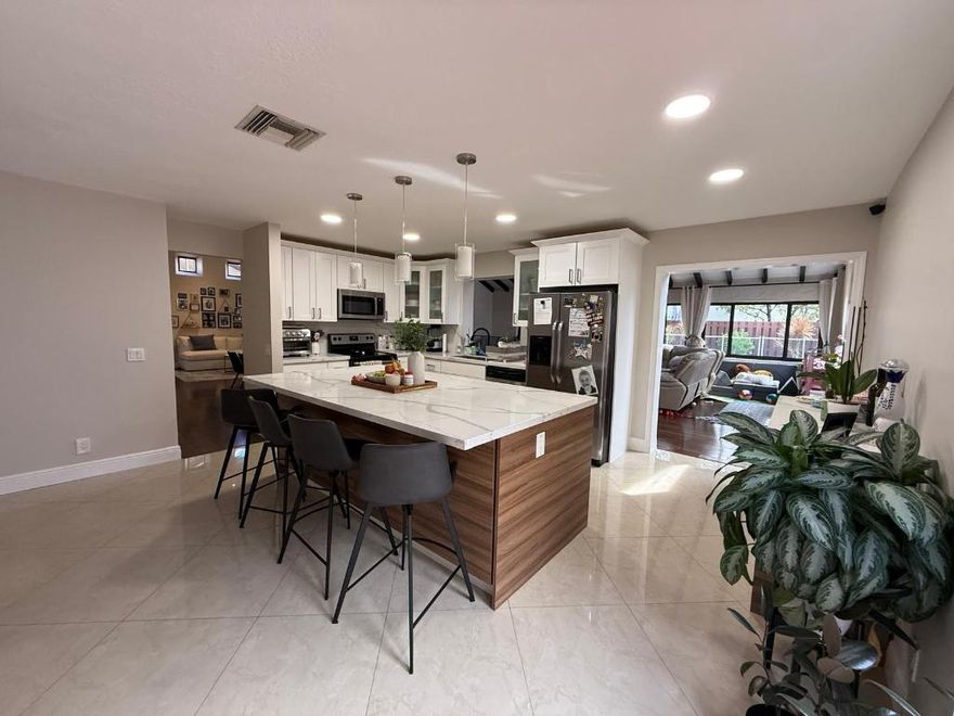 Welcome to this beautifully updated 4-bedroom, 2-bath home in the heart of Weston! This residence features a modern renovated kitchen with sleek finishes, updated bathrooms, and a bright, open layout perfect for comfortable living. Enjoy indoor-outdoor living with an enclosed patio, ideal for relaxing or entertaining year-round. The backyard is designed for low maintenance and maximum enjoyment, featuring artificial turf and a private plunge pool -- perfect for unwinding after a long day. Nestled in a quiet, family-friendly neighborhood with access to A-rated Weston. Impact windows throughout home, NEW water filter and washer and dryer. MUST SEE!