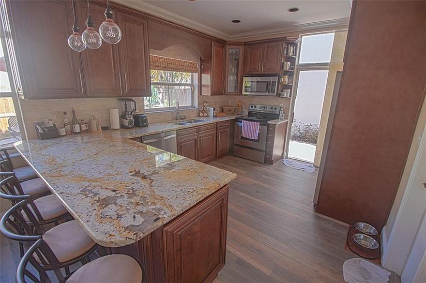 Unique 2 story Hollywood home that has been beautifully updated.  Featuring granite coutertops and SS appliances the open kitchen is great for entertaining and hosting guest!  Lots of windows bring in nice natural light and has 3 full bathrooms!  One bedroom and bath downstairs and, 2 bedrooms 2 baths upstairs.  Not only is this beautiful home in great community it is in a great location with quick access to multiple shopping centers like Oakwood Plaza, Sheridan Plaza, and the new Dania Point.  Also offers quick access to 95, 595, and Ft. Lauderdale airport.  This friendly community also features a children's playground, pool, and gym.  Very affordable HOA fees which includes over 100 channels of basic cable.  Comes with Home Warranty!  Check out this hidden gem, you won't be disappointed!