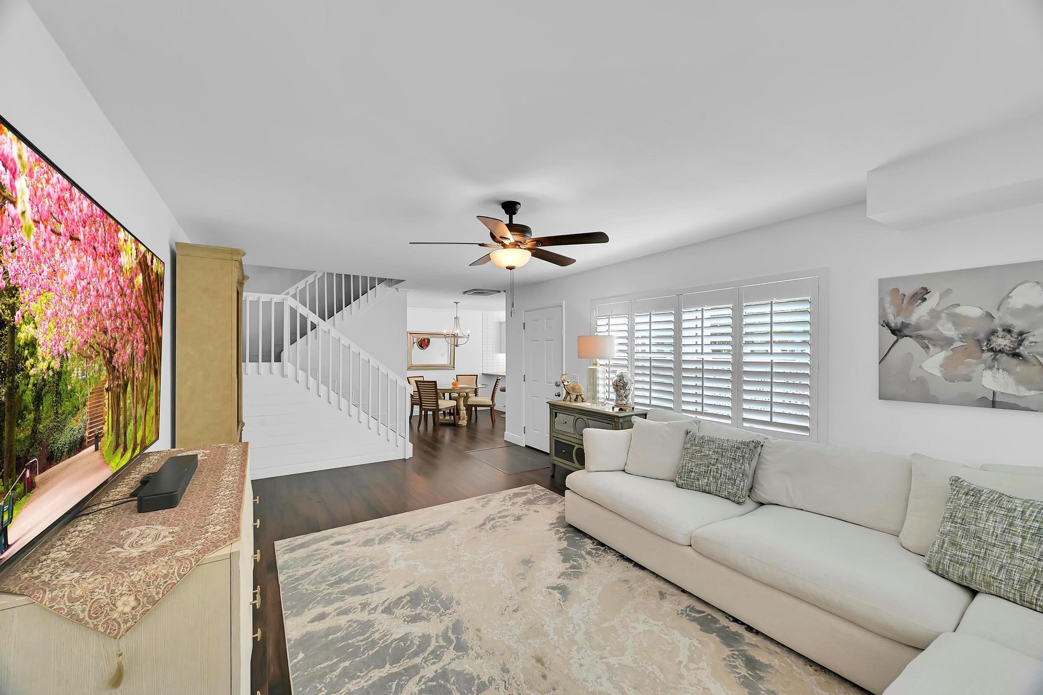 Beautifully RENOVATED Palm City townhome-your tropical oasis awaits!Stunning COURTYARD style residence offers over $75K in renovations including smooth ceilings, luxury vinyl flooring, LED lighting, upgraded bathrooms, white shaker cabinets with granite countertops & high end appliances. Enjoy IMPACT WINDOWS, NEW ROOF(2022) and OPEN LAYOUT designed for modern Florida living. Two deeded parking spaces and a private courtyard add comfort and style. The gated community features 2 swimming pools, tennis courts and lush tropical landscaping. Walking distance to A-rated schools with easy access to main roads, shopping, golf and beaches. Low homeowners Insurance as exterior is covered by the HOA. A true gem blending luxury, convenience & resort style living. Just bring your tooth brush & enjoy