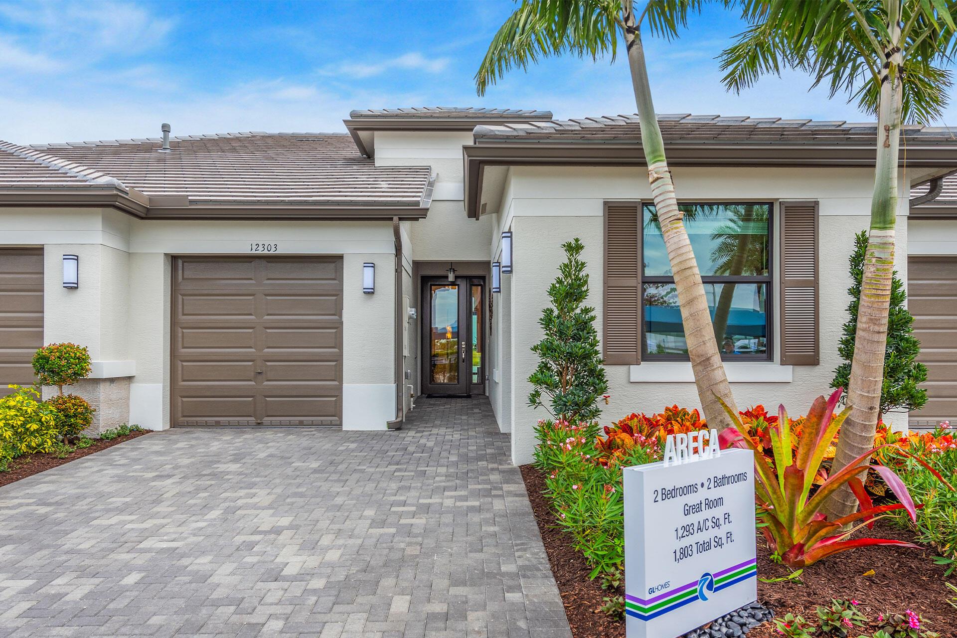 Valencia Parc at Riverland is where you'll find Port St. Lucie's best 55+ lifestyle with a million ways to have fun including a beautiful 38,000-square foot Clubhouse with resort-style amenities. This Areca floorplan includes private views and an open floor plan with matte tile flooring throughout the entire home. The home features high end finishes including impact glass windows, GE gas appliances, tile roof, and recessed LED lighting. The kitchen includes high end quartz countertop with designer marble backsplash, painted gray mist maple cabinets, and GE stainless-steel appliances with a chimney hood. All bathrooms include high end quartz countertops and painted grey mist maple vanity cabinets.