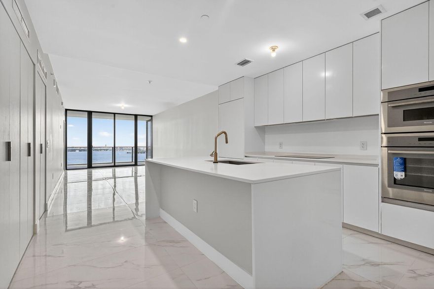 This one's on the 30th floor : higher, brighter, and with that full bay view everyone asks for. Offered furnished at $11,000 or unfurnished at $10,000. Same clean finishes, but with more light and privacy. Custom closets, drapes, shades, and lighting will be done. Two bedrooms plus office, three baths, one garage, one valet. Move-in ready in two weeks. Amenities are next level: pool, spa, gym, courts, kids' areas, and a private wine cellar. You're right between Midtown, Wynwood, and the beach. Visit today!!!