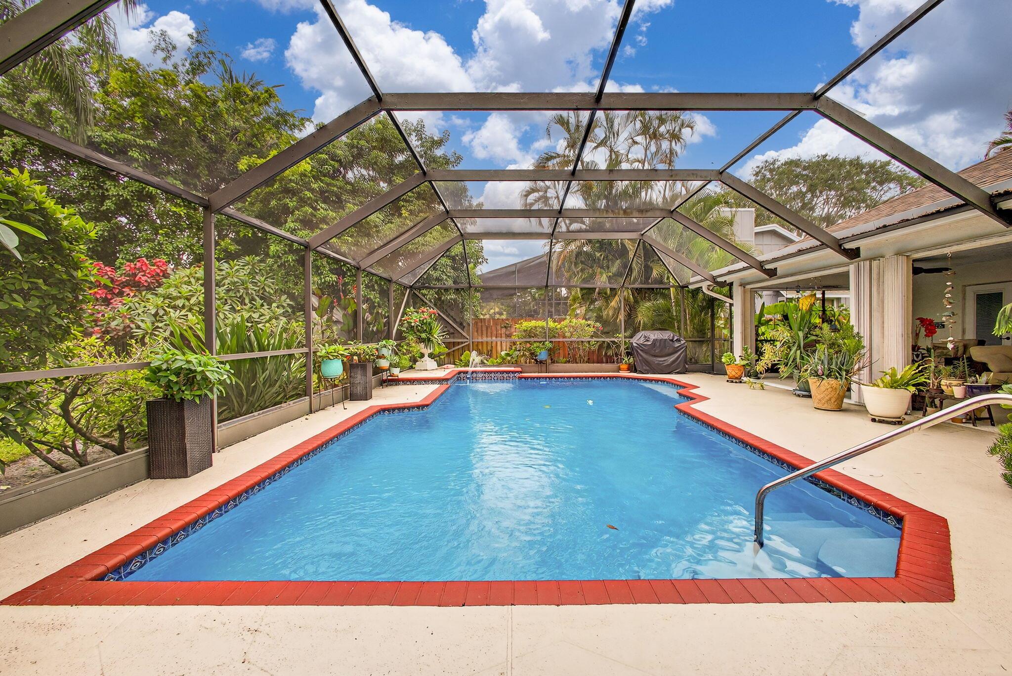 POOL home-HO HOA!This 3 bedroom,2 bath in Wellington is ready for a new familyOpen kitchen includes high-end appliances, granite counter tops and a beautiful glass-tile back splash and tile floors throughout. Vaulted ceilings make the home feel spacious and bright. Both baths are beautifully renovated to give you a spa like feel.All bedrooms have large walk-in closets w/ wood closets systems. Impact windows, skylights and leaded front door. The large covered patio is perfect for entertaining. The heated pool is saltwater and over looks a canal and preserve. The spacious yard is fully fenced with a separate dog run on the side. Enough room for an RV /boat. NEW AC AUGUST 2025Roof 2021, new diamond brite pool finish. New washer and microwave.New electric panel and HWH 2024