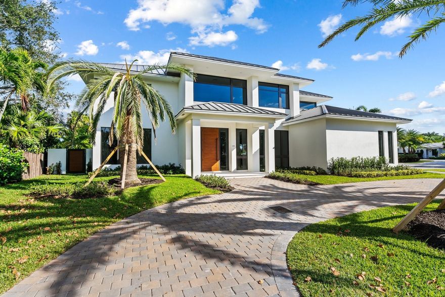 Spectacular new-build by award winning builder/designer Glenn Wright on a beautiful huge corner lot in Coral Ridge. Masterfully created to raise the bar in contemp architecture w/floor to ceiling windows for full length views of the landscaped tropical & spacious backyard. Sophisticated open floor plan w/5 bedrooms & 6 baths, plus an office! A transitional smart home masterpiece featuring a crackling fireplace for intimate gatherings in the 21' tall great room, A Chef’s Custom kitchen with Dacor Appliances. The outdoor cooking area compliments the best of poolside living/dining with a massive oversized lanai. Spa-like ambiance w/luxurious bathroom accoutrements in primary suite plus two walk-in closets. 3-car side loading garage makes for a full and very attractive front elevation.