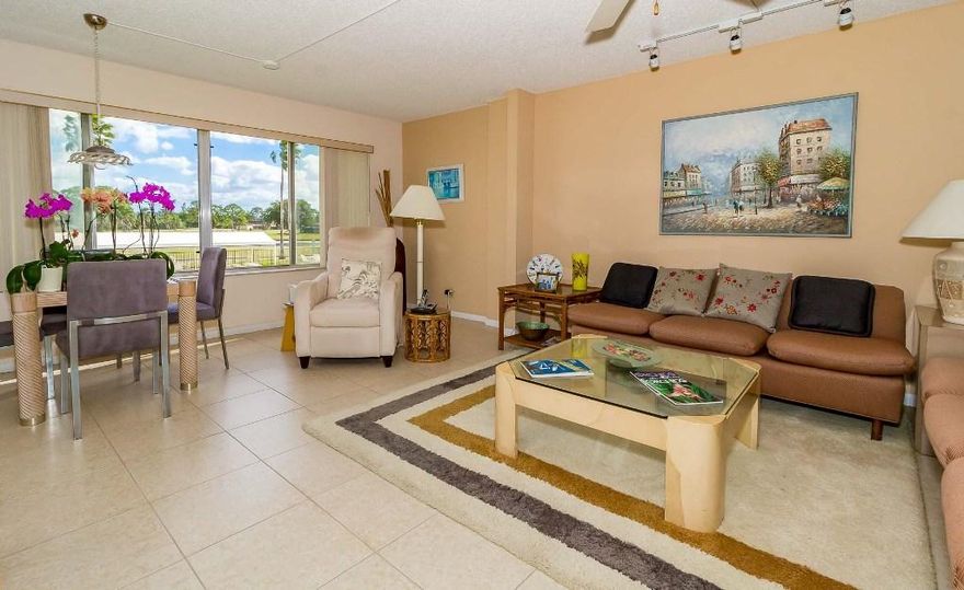 This home is a beauty!  1400 sf of indoor living space that boasts 2 bedrooms, 2 full size baths with views of the pool, golf and partial lake. Tile throughout main living areas, laminate in bedrooms.  Lovely eat in kitchen with large pantry, washer and dryer in closet.   Spacious dining area with extended living room.   Separate guest room with wall to wall closets, plantation shutters and easy access to hall bathroom with combo tub shower, new vanity and lights.  Beautiful views from the master bedroom window overlooking the golf course, lake and pool.   New vanity in master bathroom with step in shower.   Huge walk in closet.   Lots of closet space. Condo is sold furnished!  Wonderful clubhouse with Mel's restaurant and many amenities to quench everyone's taste.