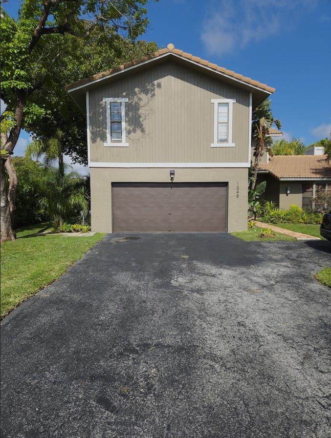 Beautiful waterfront Two Story home with 4 Bedrooms, 2 ½ baths plus Den, 2-Car Garage with a lovely fenced in pool located in the desirable neighborhood of Cypress Run in Coral Springs, Florida. This incredible floor plan has been designed with spacious living areas in mind. From the moment you enter through the double doors into a large open living and dining room, you will be mesmerized by a unique modern looking fireplace. Living and Dining rooms have incredible vaulted ceilings and receive beautiful natural light throughout the main living space. Sliding doors in the Living Room look out to the gorgeous outdoors with views of the beautiful waterfront pool. The backyard has great space for entertainment, has a covered lanai as well as a pergola.