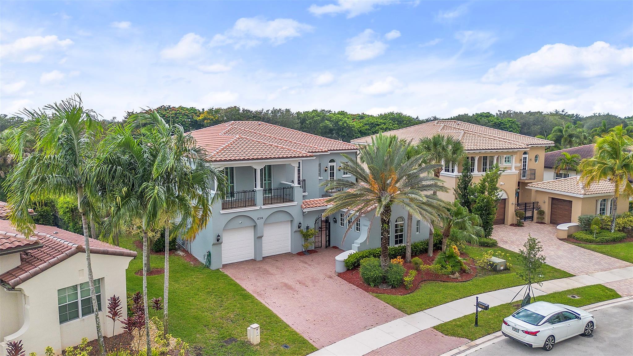 STUNNING 6 bed 4 bath waterfront pool home with a private 1 bed, 1 bath guest house in the exclusive Banyan Isles at Heron Bay. The guest suite is ideal for a home office or in-law quarters. This beautifully maintained residence features a spacious kitchen with an oversized island, abundant storage, jacuzzi & pool overlooking serene lake views. The primary suite offers dual custom closets, private balcony & a spa-style bath with jetted tub. Upstairs bedroom has its own private balcony, epoxy-finished garage with ample storage & central vacuum. Resort-style amenities including clubhouse, multiple heated pools, state of the art fitness center's, sauna's, hard/clay tennis courts, indoor racquetball, basketball courts, kids spray park & grill area, ball rooms, 24-hour security & MUCH MORE!!!