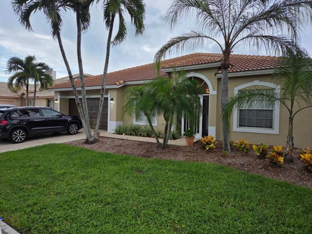 Photo of 2724 Pointe Circle, Greenacres, FL 33413 (MLS # R11125769)