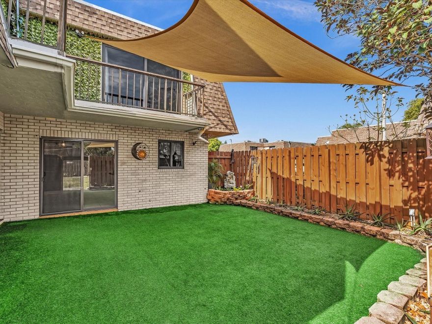 Oversized, move-in-ready townhouse offering the space and feel of a single-family home. Tile and laminate flooring throughout. IMPACT WINDOWS & DOORS, TANKLESS WATER HEATER 2020. A/C 6 years old. Updated kitchen w/granite countertops, glass tile backsplash, breakfast bar & separate dining area. Remodeled half bath w/laundry room. Spacious master bedroom fits a king-size bed; remodeled primary bath w/ skylight & double vessel sinks. Bedrooms feature sliding doors w/ balcony access & abundant natural light. Very private courtyard is fenced & covered w/ turf providing additional space ideal for outdoor festivities. Association covers ROOF, WATER, SEWER, EXTERIOR & COMMON AREAS. Your additional expenses: electric & cable/internet.  NO CREDIT OR INCOME REQUIREMENTS. Two assigned parking spaces.