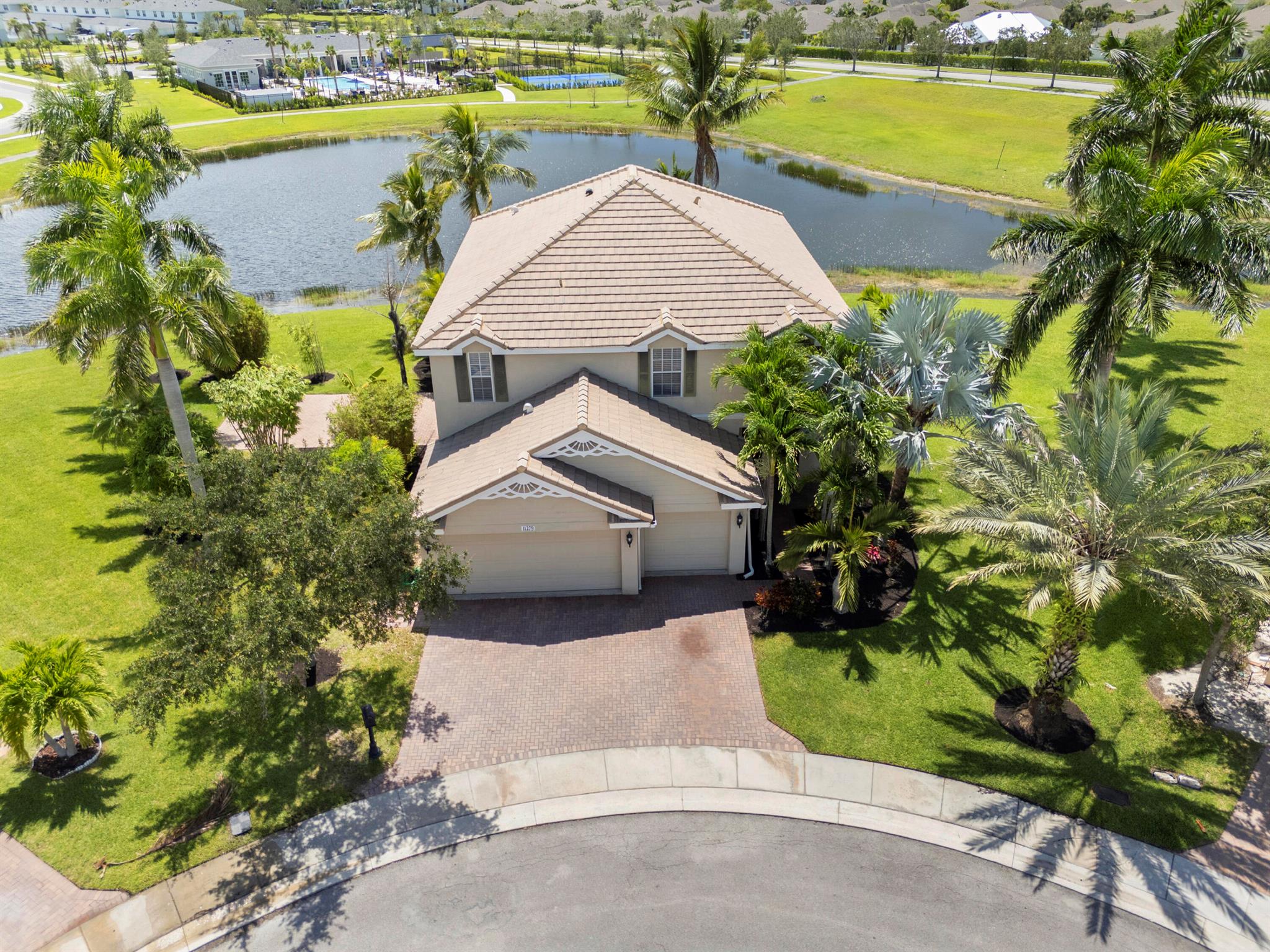 LAKESIDE LOCATION IN THE HEART OF TRADITION! This 5BDRM/2.5BA/3CG 2-story home is nestled on a .29 acre cul-de-sac lot within the popular community of VICTORIA PARC! Surrounded by tropical landscaping, mature palm trees, extended paver patio to enjoy, and exceptional water views this property is a TRUE GEM and a MUST SEE! Plenty of room for the whole family in this great room style plan with multiple living areas, large kitchen w/wood cabinets, pantry, granite counters, SS appliances & cozy breakfast area overlooking the lake! Stairs to upper level take you to the relaxing Master Suite w/ tray ceiling, walk-in closet and spa-inspired ensuite w/ double vanities, soaker tub & tiled shower! Four additional bedrooms, a guest bathroom & conveniently located laundry room complete this level.