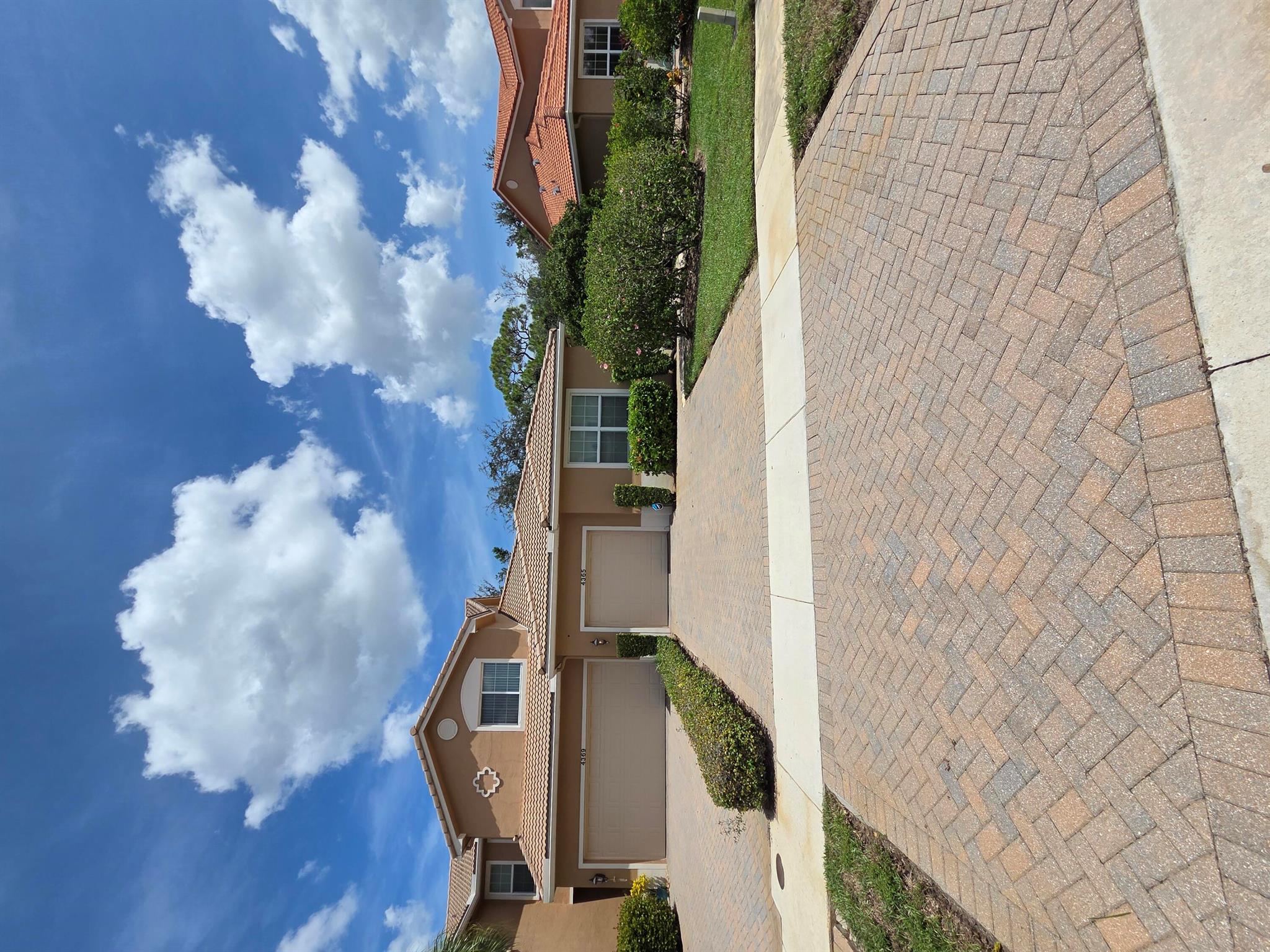 This bright and stylishly upgraded 2-bedroom, 2-bath end-unit with a 1-car garage is tucked inside a quiet gated community--just minutes from everything you need. Move right in and enjoy tile and laminate flooring, an updated kitchen, impact windows and sliders, elegant tray ceilings in the primary suite, seamless glass showers, crown molding throughout, and even a double driveway for extra convenience.Step outside to your private brick-paved patio--perfect for morning coffee, evening wine, or weekend entertaining. And here's the magical touch: graceful peacocks often wander by, bringing a unique sense of charm to everyday life.Zoned for a highly rated 8/10 elementary school and ideally located near shops, dining, and major highways, this villa checks every box for comfort & style.