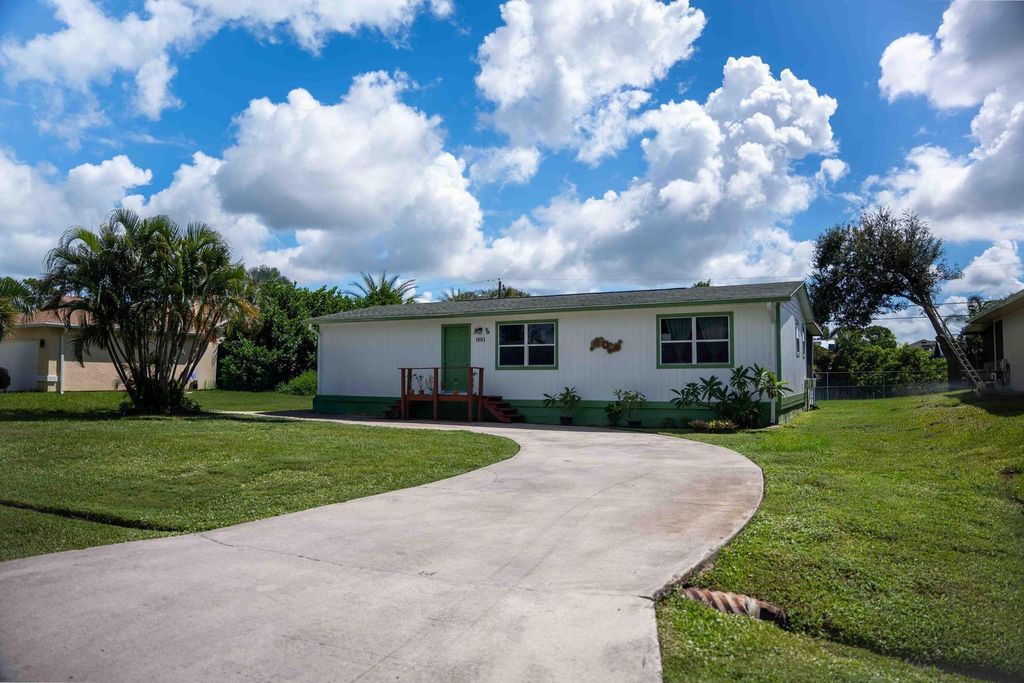 Photo of 1881 SE Manth Lane, Port Saint Lucie, FL 34983 (MLS # B26038033)