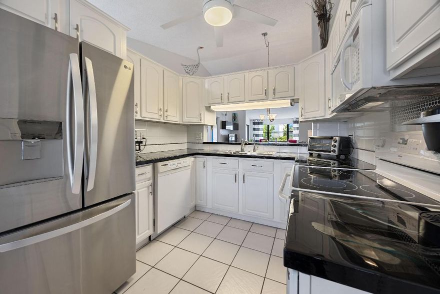 Super clean, nicely decorated and lovingly maintained  2nd floor 2 bedroom 2 bath condo. Spacious living room with den area and great cathedral ceilings. Lots of light. Updated eat-in kitchen with pretty counters and  backsplash, a pantry and a lovely built-in breakfast nook. Nice primary suite with an unusually large walk-in closet with lots of shelving and a bathroom with a new glass shower door. Updated 2nd bathroom with new vanity, new tile floor and light fixture. Inside utility closet with full-size washer and dryer. Big storage closet on the lanai. Sold furnished and ready to move-in.  Located in Lucerne Pointe a 55+community, with a large clubhouse, pool, great fitness center, tennis and within walking distance  to the satellite pool