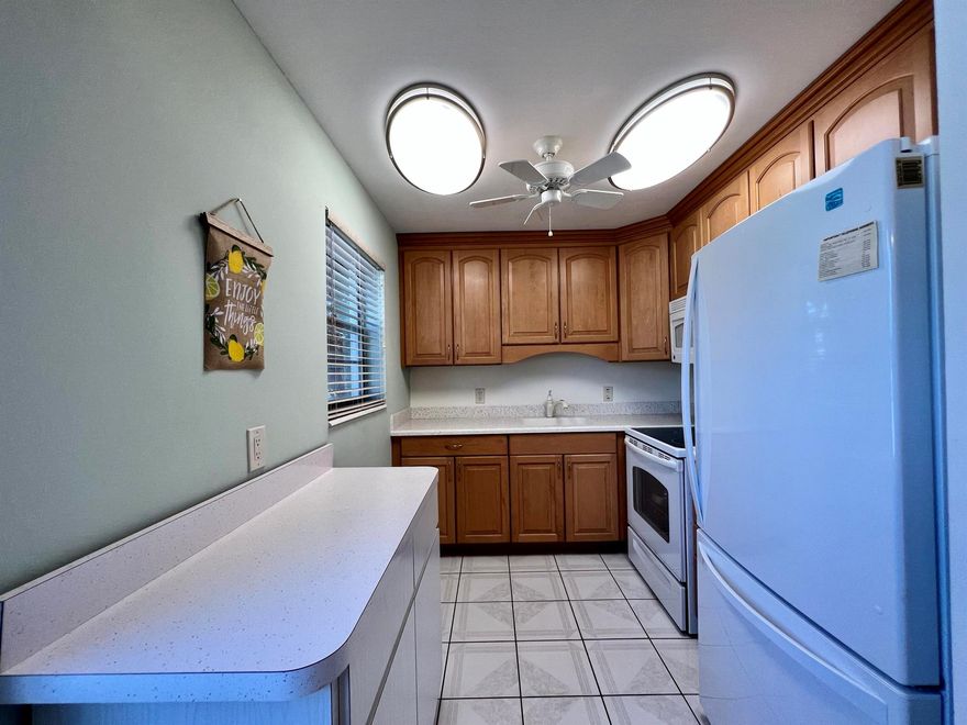 Rare Rental Opportunity in 55+ Century Village! First Floor CORNER 2/1.5 Annual Rental. Updated Kitchen & Baths. Kitchen Updated With Wood Cabinetry, Corian Counters, and Updated White Appliances. Full Bath Updated With Step-in Shower. Neutral Tile Flooring Throughout. Central AC. Long Enclosed Lanai with Tile Flooring. Century Village is a 55+ community with so much to offer...