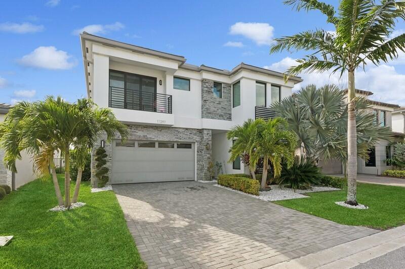 This home was spared no expense on upgrades. This beautiful 4 bedrooms 4.5 bathrooms (Moorea Model) is in the esteemed Lotus community in Boca Raton. The first floor offers a guest suite with full bathroom along with another half bath. This house has so much to offer - custom designed finishes and touches, recessed ceiling lights, black & gray Brazilian glass cabinetry, wood flooring, electric shades all with security & lighting controllable online. Next to the dining room is a striking chef's kitchen, Samsung Smart Fridge, impressive custom-built plate ware display, stainless steel appliances, wine and beer cooler, and BLUM hardware cabinetry. 2nd Floor offers 3 additional bedrooms with full baths and a Loft/Office area. Master bedroom offers 2 large walk-in closets.