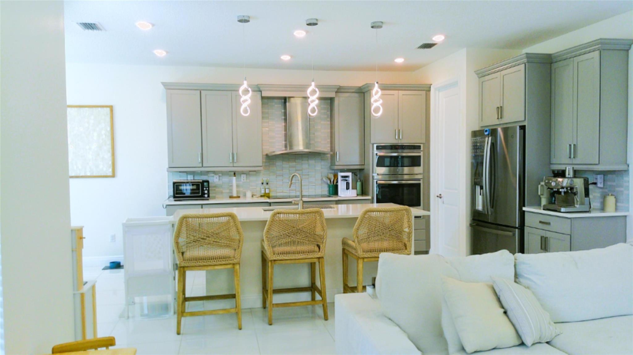 Built in 2020, this spacious 5-bedroom, 3-bathroom home offers breathtaking lake views in the sought-after Veleiros at Crystal Lake community. The gourmet kitchen features sleek finishes, a walk-in pantry, and seamless flow into the grand living and dining areas. A convenient first-floor bedroom and full bath provide flexibility for guests or a home office. Upstairs, the lavish master suite boasts lake views and en-suite bathroom and ample closet space, plus three spacious bedrooms, a den, and a convenient laundry room. Step outside to a covered lanai and serene waterfront setting. Enjoy ultra-low energy costs with solar panels and a lake-fed sprinkler system. Indulge in resort-style living with a clubhouse, zero-entry pool, children's playground, and fitness center with a kids’ room.