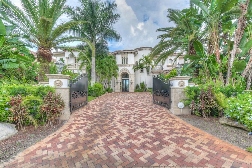 Stunning waterfront custom built home with all high end finishes throughout. 116' of water frontage in a no-wake zone with the dock capacity to hold over 100' yacht. This gated enclave is truly a masterpiece, with no detail overlooked. From the double crown molding to the mahogany baseboards this home is a work of art. Imported floors from spain, hand crafted custom doors from Central America, each finish has a story behind it. Chefs Kitchen with 2 fridges, 2 sinks, 2 ovens, 2 dishwashers, granite counter