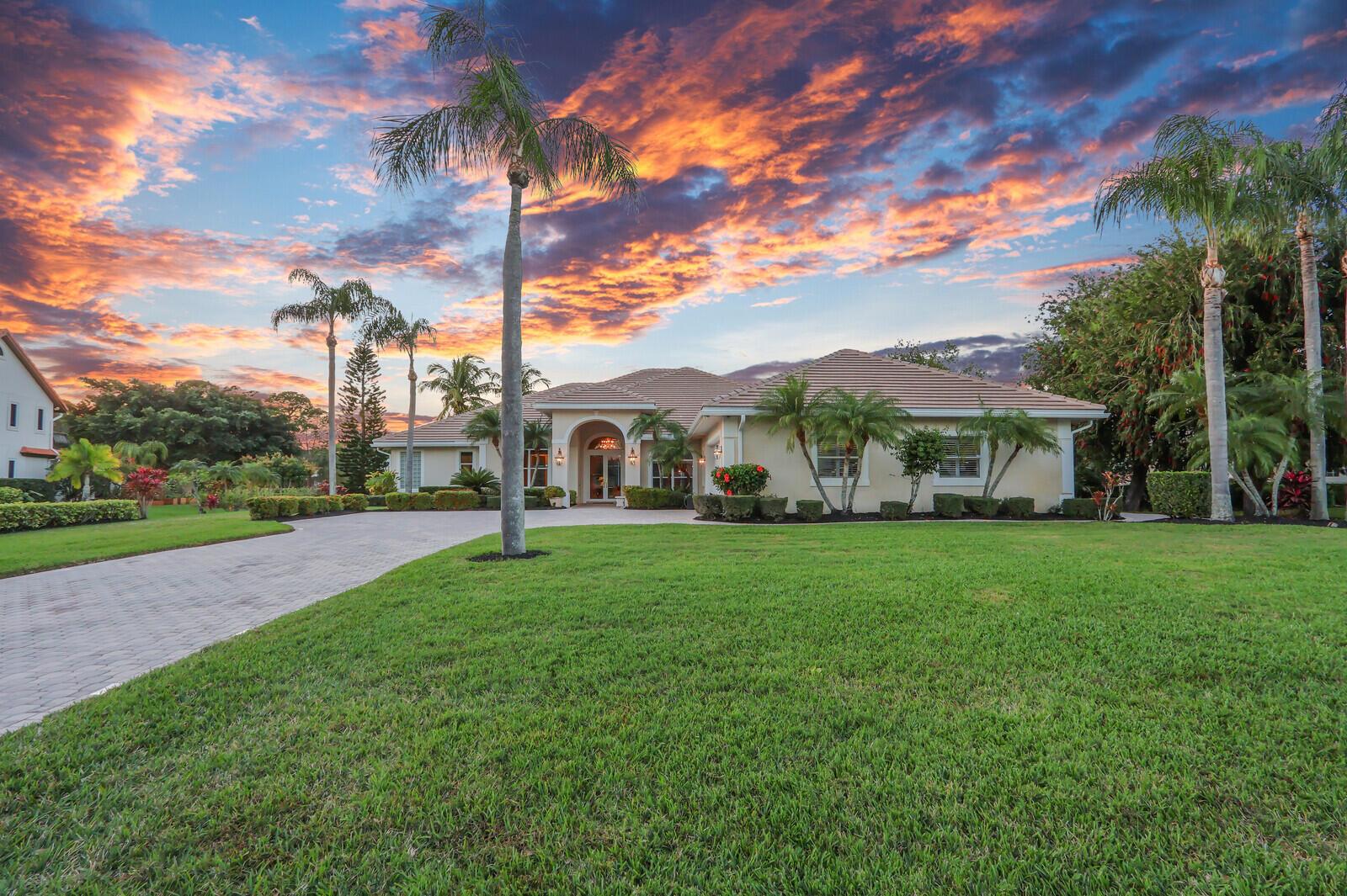STUNNING 1.49-ACRE LAKEFRONT PROPERTY offers breathtaking water views & a tranquil, private setting. Boasting 4 spacious bedrooms, each with it's own ensuite bath, this meticulously maintained, one owner home showcases exceptional craftsmanship & quality finishes throughout. This luxurious property boasts an expansive and open floor plan designed for both comfort & entertaining. Upon entering, you are greeted by a formal foyer that leads into a light-filled living space. The spacious living room is in the heart of the home, featuring large windows that flood the space with natural light & a sleek wet bar, perfect for hosting guests. Open to the kitchen is a casual family room that offers a warm & inviting atmosphere with easy access to the covered lanai, blending indoor & outdoor