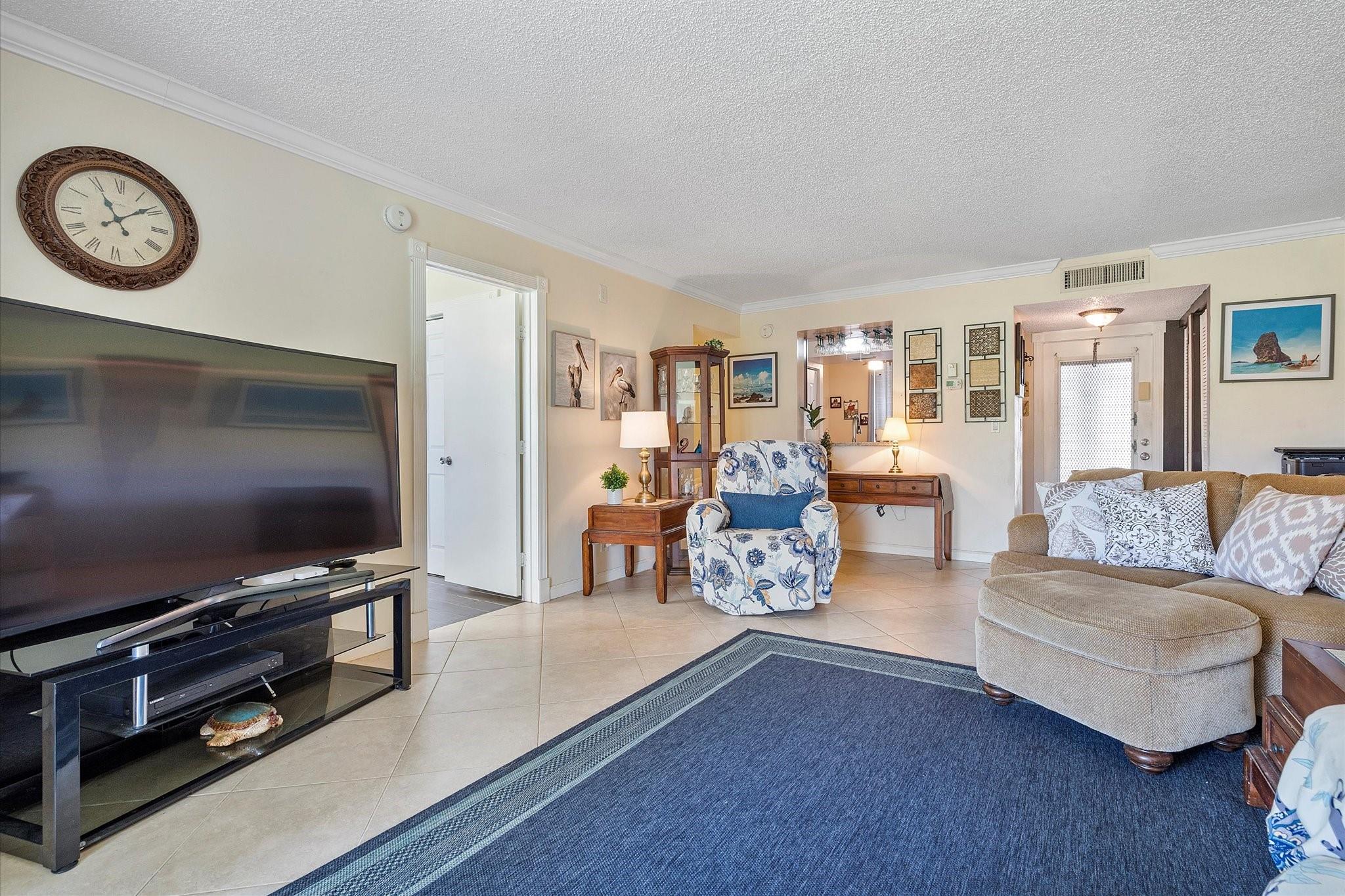 Beautiful 1st Floor Condo in Palm Springs III 55+ Community Located on the 12th fairway of the Oriole Gardens Golf Course, this newly remodeled unit features tropical decor and an unobstructed golf course view. Enjoy an extra-large living space, two spacious bedrooms and bathrooms, and a modern kitchen with granite countertops, walnut wood cabinetry, and a cozy dinette. Flooring includes walnut ceramic wood-look tile in the bedrooms, bathrooms, and closets, with 20” tile in the living area and patio. The screened patio offers a large seating area, rolling shutters, and outdoor storage. New HVAC installed (11/23) Amenities: Two pools, clubhouse, gym, pool tables, library, and social events. Close to shopping, hospitals, pharmacies, and public transit. Perfect for active, easy living!