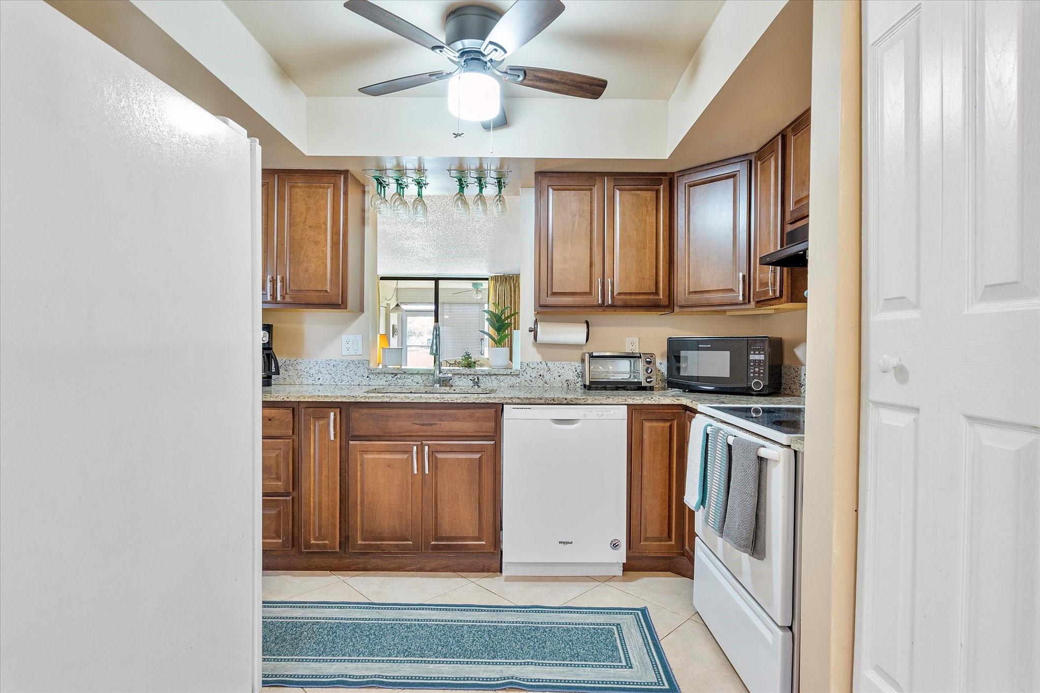 Newly remodeled 2BR/2BA condo overlooking the 12th fairway of Oriole Gardens Golf Course. Features include granite countertops, walnut cabinetry, oversized living area, dinette, and washer & dryer in the unit. Walnut ceramic wood-look tile in bedrooms; 20” tile in living areas & patio. Screened patio with rolling shutters and storage. New HVAC (11/23). Community amenities: 2 pools, clubhouse, gym, library, and social events. Convenient to shopping, hospitals, and public transit.