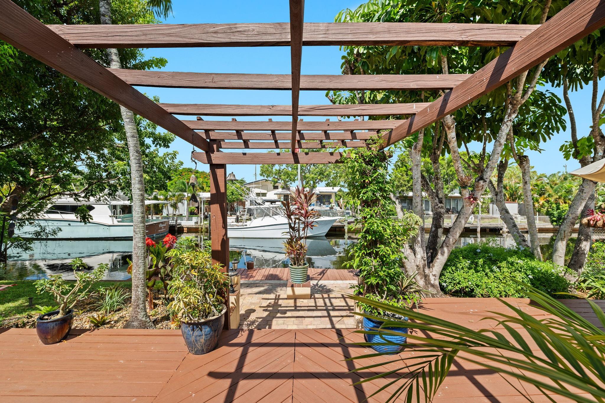 Beautifully maintained Lauderdale Isles home with thoughtful updates that help bring peace of mind. Impact windows & doors, 15' of cast iron pipe replaced under the home plus new line to city, new electrical, generator hookup, remodeled kitchen and baths—all with permits. Enjoy 65' on an ocean-access canal with no fixed bridges to the ocean, with water & electric at the 40' dock ready for your boat. Sun-filled interior with terrazzo floors and vaulted ceilings that combine vintage charm with modern comfort. Sprinklers keep lush gardens vibrant and blooming. Spacious laundry with extra storage. 1-car garage with workbench & storage. Convenient to highways, airport, and just 10-15 minutes to beaches, dining, and nightlife. A welcoming home where waterfront living feels easy and enjoyable.