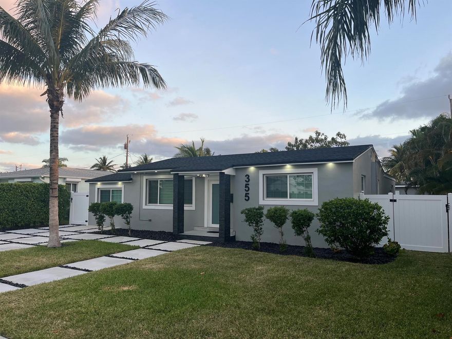 Discover this newly remodeled modern home located in Soso blocks from the Intracoastal in West Palm Beach. The property features a gourmet kitchen equipped with quartz countertops and backsplash, premium soft-close cabinetry, and Cafe appliances.Each bedroom includes updated lighting, ceiling fans, and built-in closets. The primary suite offers a private ensuite bathroom with a glass-enclosed wet room, soaking tub, rainfall shower with body jets, and a smart toilet with a built-in bidet.Recent upgrades include a new roof, air conditioning system, tankless water heater, privacy fence, driveway, and patio. The backyard is designed for both relaxation and entertaining, featuring a custom outdoor kitchen and bar. Additional highlights include an indoor laundry room, impact windows a