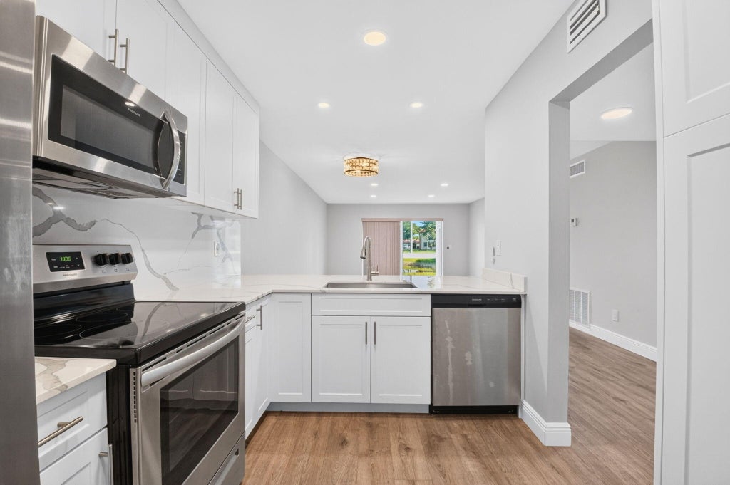 Photo of 163 LAKE EVELYN Drive, West Palm Beach, FL 33411 (MLS # B26082633)