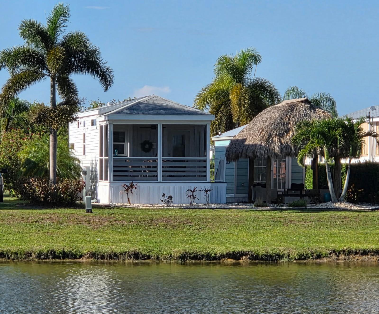 Lakefront home @ The Cottages of Silver Palms Resort, 90 acre gated community N of Lake Okeechobee, known for Bass fishing. Beautiful 1/1 cottage is decorated with a coastal vibe and upgrades , screened porch, fireplace which overlooking lake , sunshine and tranquility from porch or tiki. Tiki features outdoor furniture, fire pit, retractable lg screen TV and lighting. The casita offers you a hotel experience with sitting area,sleeper sofa, TV, storage, 1/2 bath, ac, w/d .Escape the cold and enjoy all that Silver Palms has to offer, seasonal or full-time living you will be wowed, from the owners and amenities. 5 star rated. Clubhouse with billiards,card,library & fitness rooms .Daily activities, bar & grill,, pickleball, dog park and so much more awaits you. Turnkey. SELLER FINANCING.
